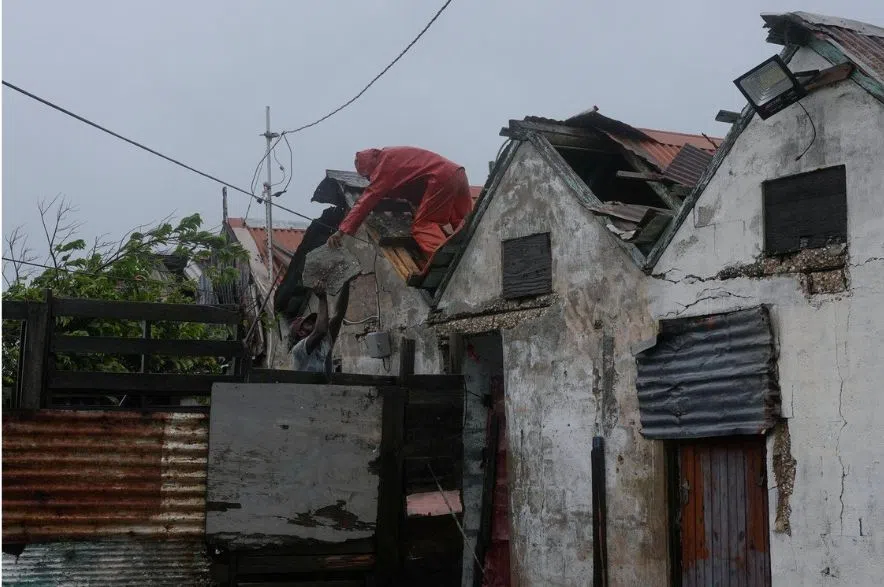 man removes section of roof from house