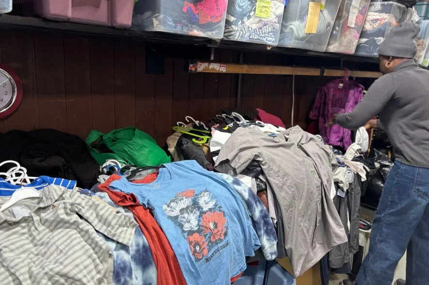 A volunteer sorts donated clothing items.