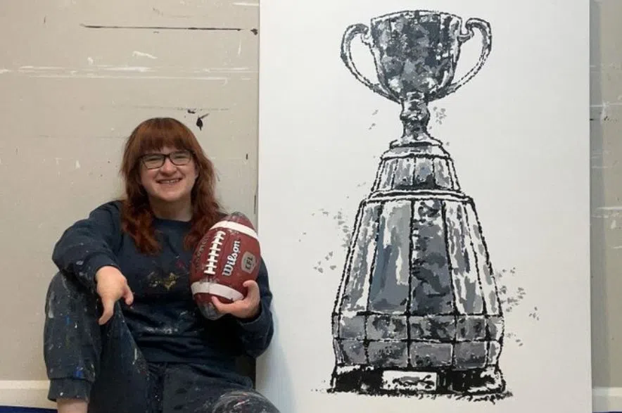 Artist Samantha Woj painted Grey Cup work using CFL ball
