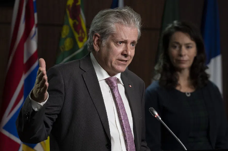 NDP MP for Edmonton Strathcona Heather McPherson looks on as then MP for Timmins-James Bay Charlie Angus speaks during a news conference on Parliament Hill, Wednesday, Sept. 21, 2022 in Ottawa.