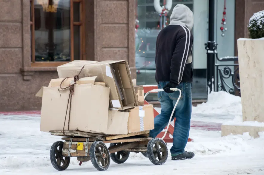 Man with cart walking in snow.