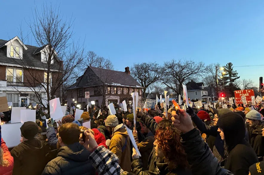 Demonstrators gather during a vigil near where an Immigration and Customs Enforcement officer shot and killed a woman in Minneapolis, Wednesday, Jan. 7, 2026.