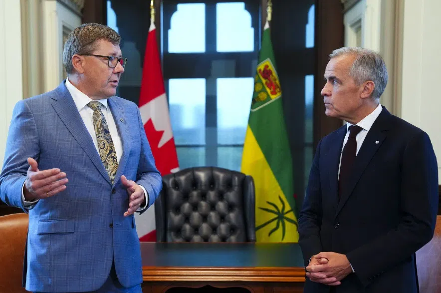 Scott Moe and Mark Carney.