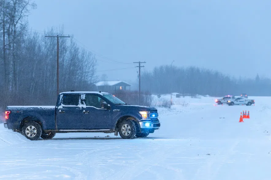 An RCMP road blockade is shown at Big Island Lake Cree Nation, 392 kilometres northwest of Saskatoon, on Tuesday, Dec. 30, 2025.