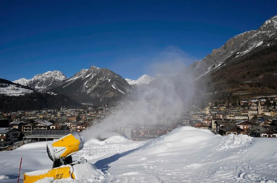 A snow gun sprays artificial snow at the Stelvio Ski Center, venue for the alpine ski and ski mountaineering disciplines at the 2026 Milan Cortina Winter Olympics, in Bormio, Italy, Jan. 16, 2025.