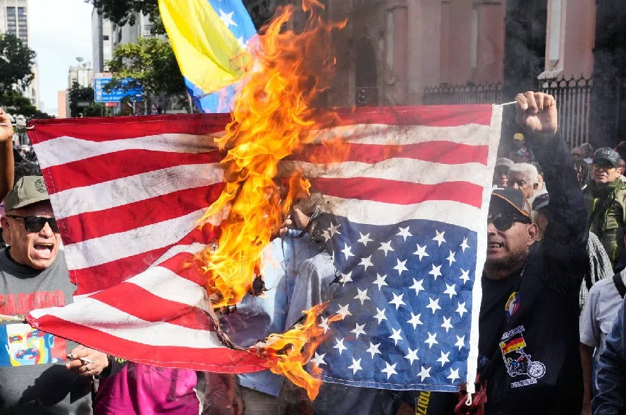 Government supporters burn a U.S. flag in Caracas, Venezuela, Saturday, Jan. 3, 2026, after U.S. President Donald Trump announced that U.S. forces had captured Venezuelan President Nicolás Maduro and his wife.