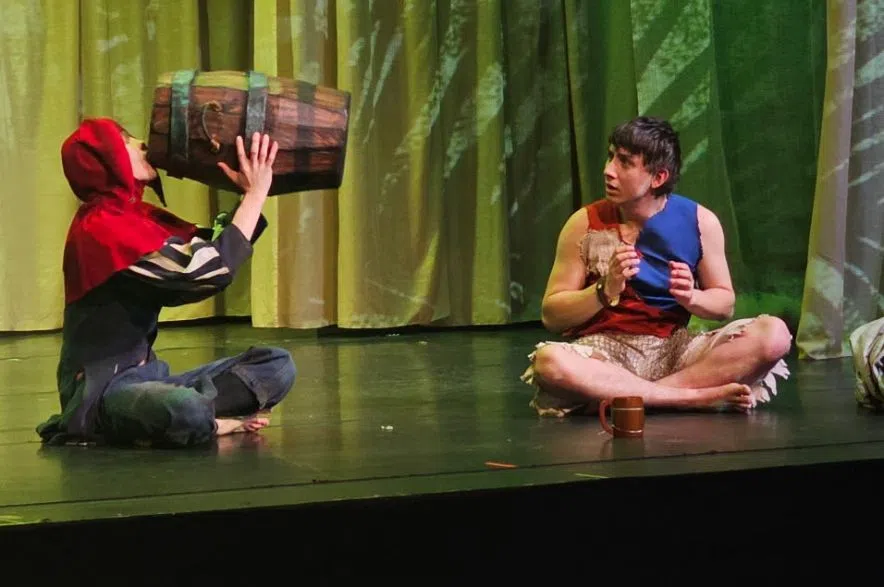 Actors seated using props during Deaf Tempest wordless Shakespeare production