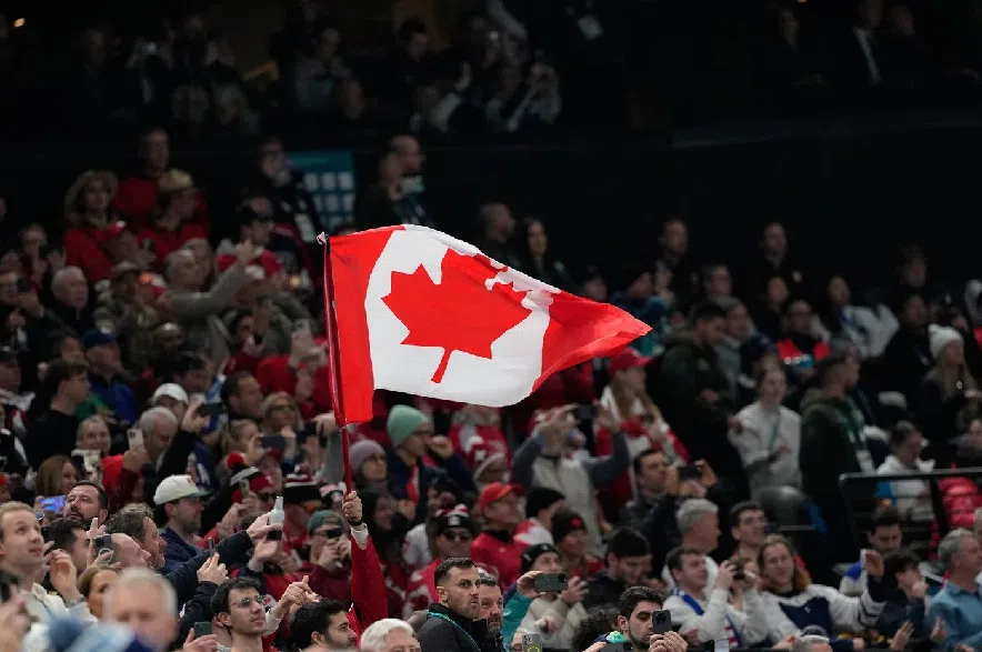 Fans wave a Canadian flag at the 2026 Winter Olympics in Milan, Italy, on Sunday, Feb. 22, 2026.