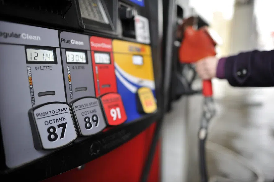 A motorist reaches for the pump at a gas station in Toronto on Thursday, Feb. 24, 2011.