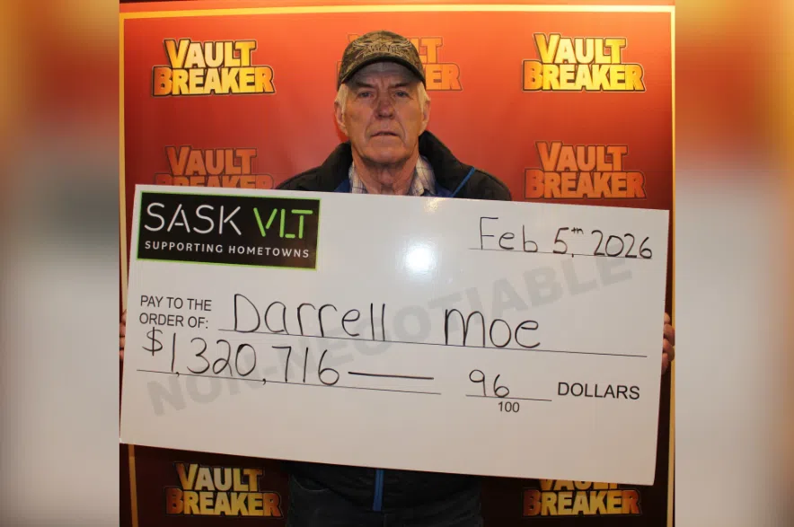 Sask VLT winner Darrell Moe holds large cheque for $1.3 million.
