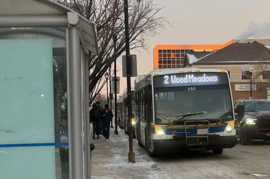 A Regina Transit bus stopped at a shelter.