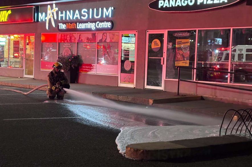 A Regina firefighter bleeds water out of a hose after a fire at a strip mall on Sept. 25, 2026.