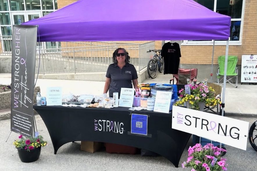 Deana Peterson runs the WeyStrong kiosk at an event.