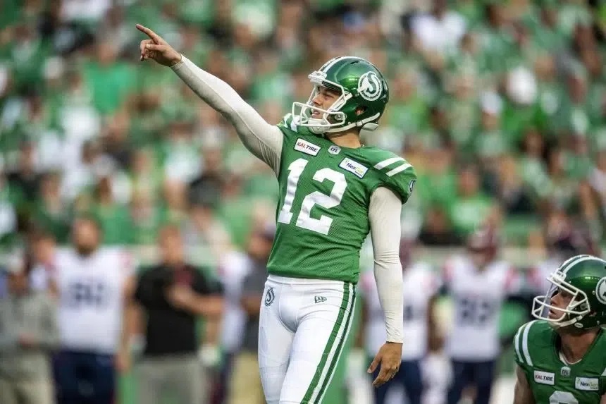 Kicker Brett Lauther points ahead of a kick during a CFL game.