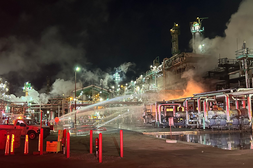 Firefighters spray water after a fire broke out at Regina's Co-op Refinery Complex in March of 2025.