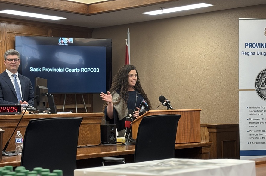Megan Jasper speaks at a podium during the Regina Drug Treatment Court’s 20th anniversary celebration.