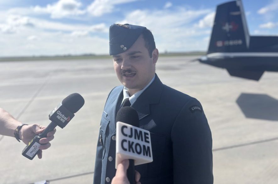 Second Lieutenant Maxime Blouin speaks with reporters on the tarmac at 15 Wing Moose Jaw.