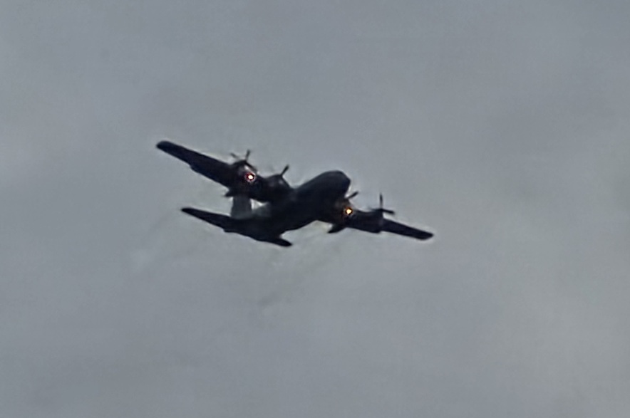 A plane, identified by a witness as a C130, searches over an area where a small plane crash occurred near Kisbey, Sask., on Sept. 18, 2026.