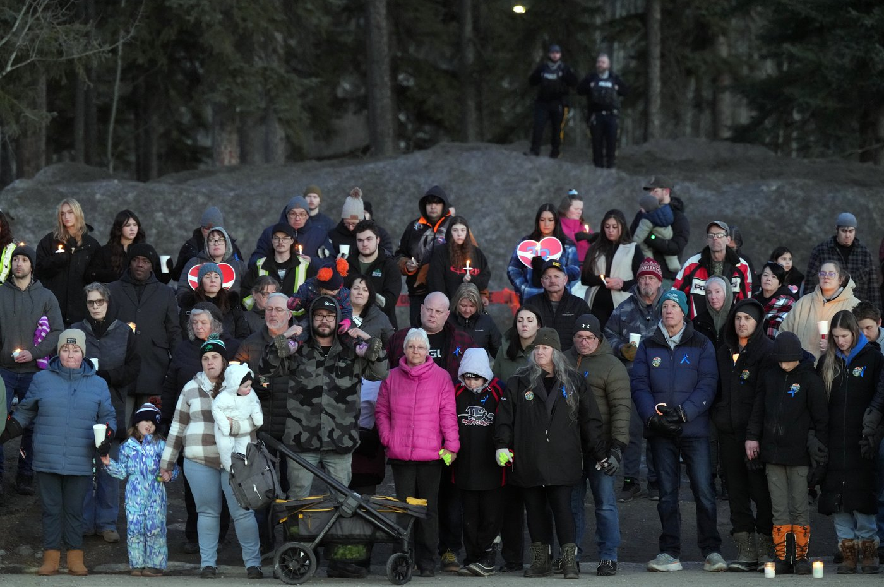 People attend a vigil for the victims of a mass shooting in Tumbler Ridge, B.C., Friday, Feb. 13, 2026.