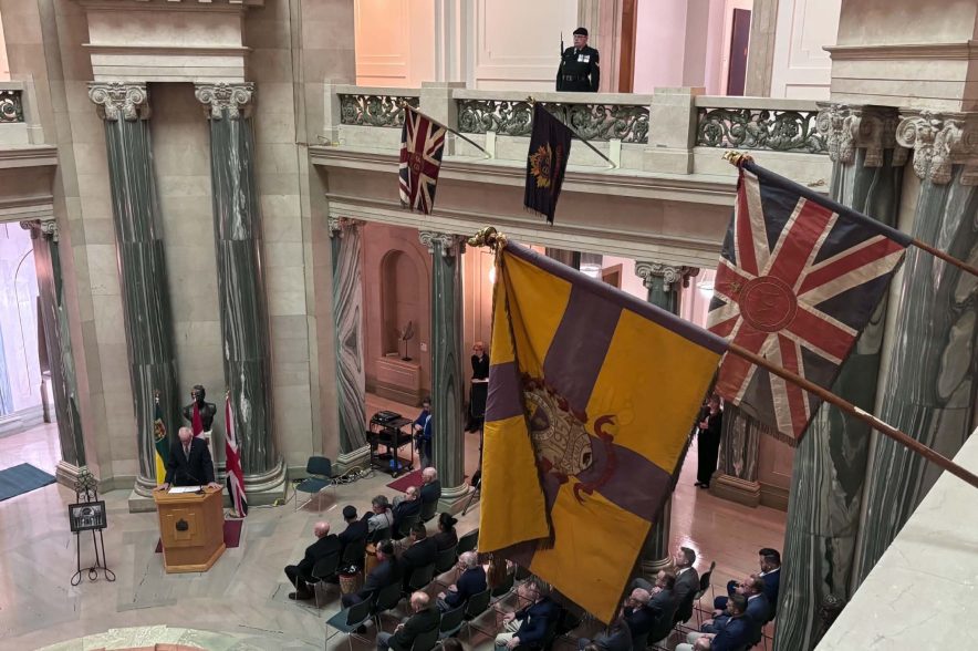 Eight flags representing four battalions hang is the Legislative Building.