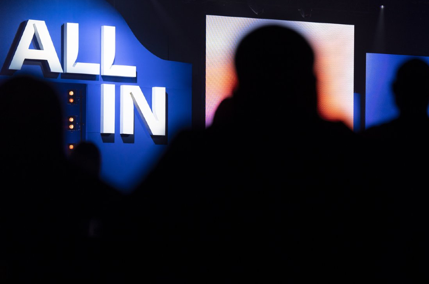 People wait for speakers on the main stage at All-In 2026, an artificial intelligence (AI) conference in Montreal.