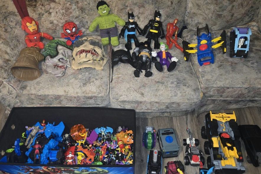 A collection of superhero toys belonging to Regina boy Tony Dubois, including Batman, Spider-Man, Iron Man and the Hulk, displayed on a couch.