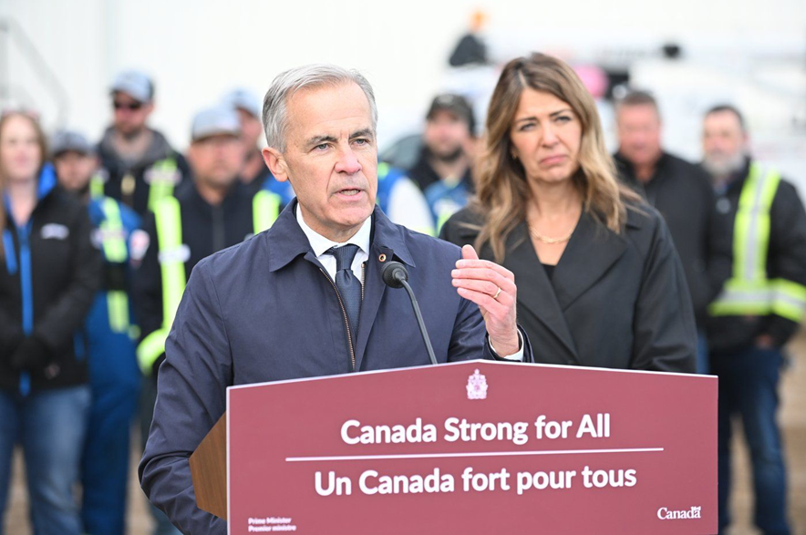 Prime Minister Mark Carney speaks as Alberta Premier Danielle Smith listens in Fort McMurray on Thursday Oct 1, 2026. Prime Minister Mark Carney declared the Pacific Link pipeline project to be in the national interest.