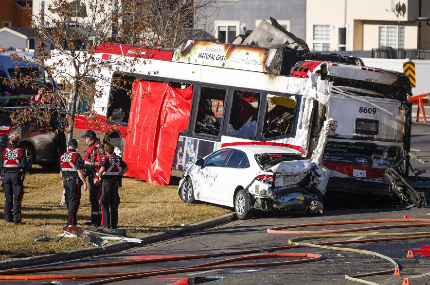 Police and fire personnel attend the scene of a fatal bus crash in Calgary, Thursday, Oct. 15, 2026.