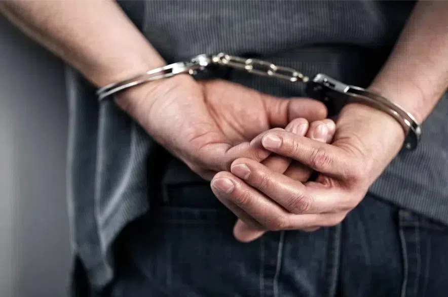 A man with his hands cuffed.