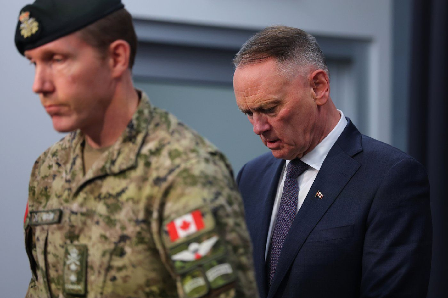 National Defence Minister David McGuinty, right, and Major-General L.W. Rutland attend a press conference in Edmonton, Sunday, Oct. 18, 2026.