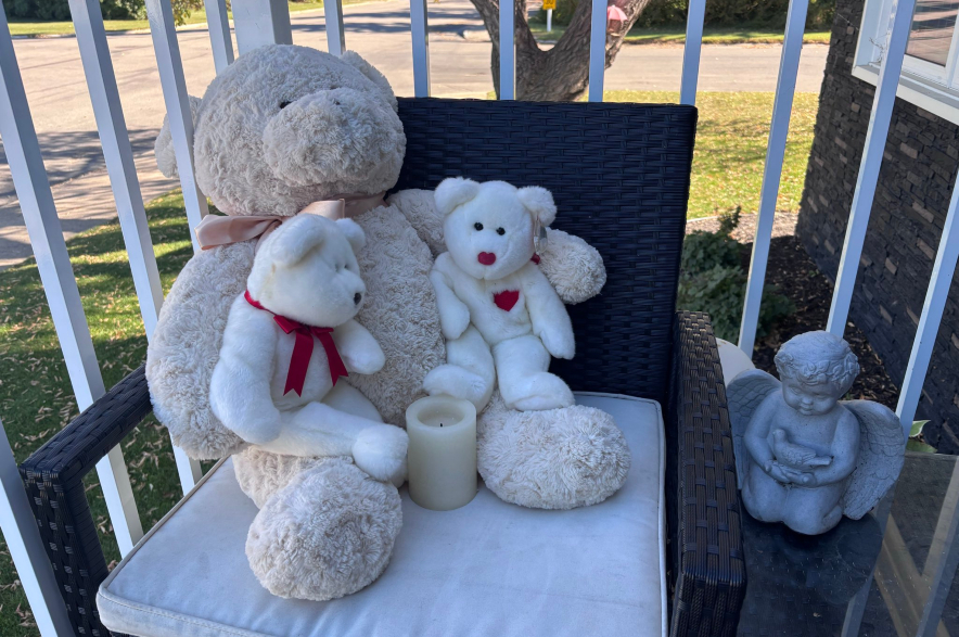 Stuffed animals sit outside a home in Foam Lake.