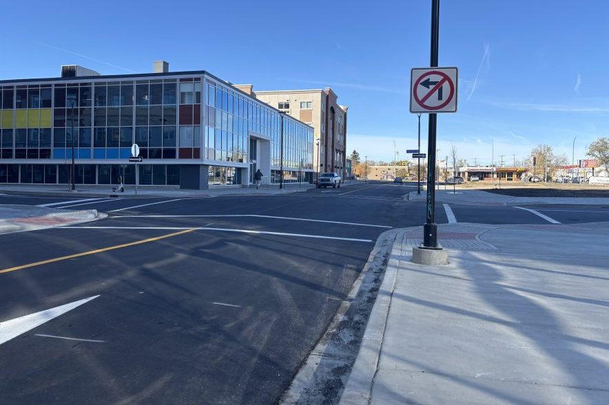 Newly reconstructed 11th Avenue near McIntyre Street in downtown Regina, featuring fresh asphalt, wider sidewalks and surrounding downtown buildings.