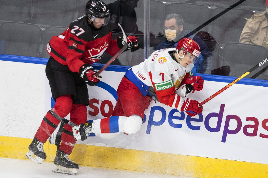 Canada's Will Cuylle (27) checks Russia's Arseni Koromyslov (7) during world junior hockey exhibition action in 2021.