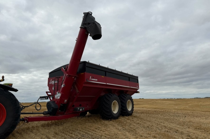 Farming equipment sits in a field.