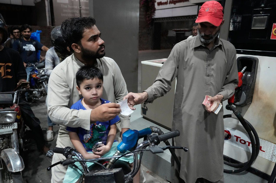 A motorcyclist gets fuel on subsidised rates in Pakistan.
