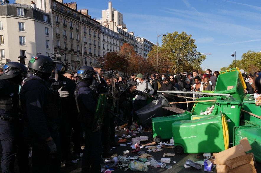 Riot police face high school students as they gather before a demonstration against under-resourced schools in Paris, Tuesday, Oct. 6, 2026.