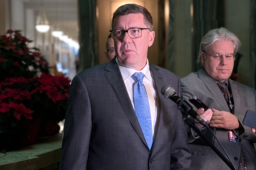 Premier Scott Moe speaks to reporters