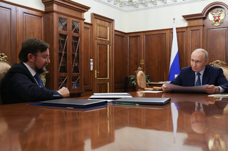 Russian President Vladimir Putin, right, listens to head of the Delovaya Rossiya (Business Russia) National Public Organisation Alexei Repik.