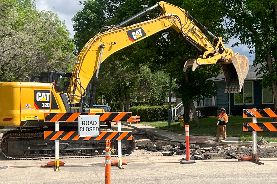 An excavator works on road construction in Regina.