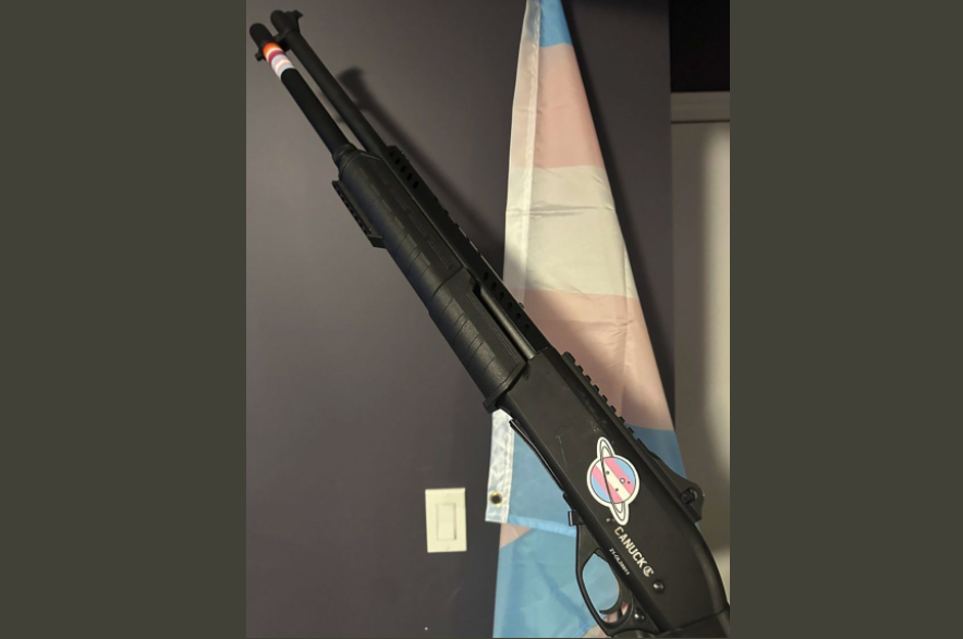 A photo of a gun decorated with stickers.