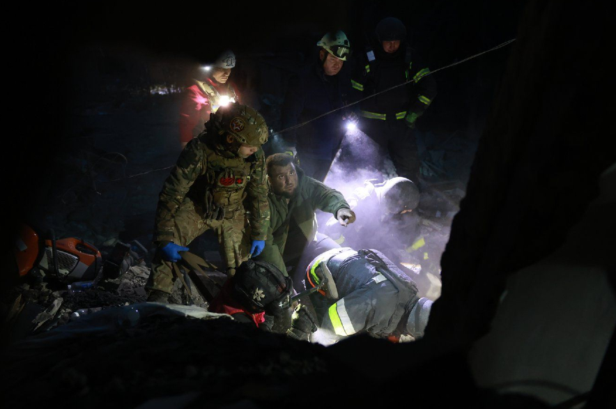 Rescue workers clear the rubble of a residential building destroyed by a Russian airstrike in Zaporizhzhia.