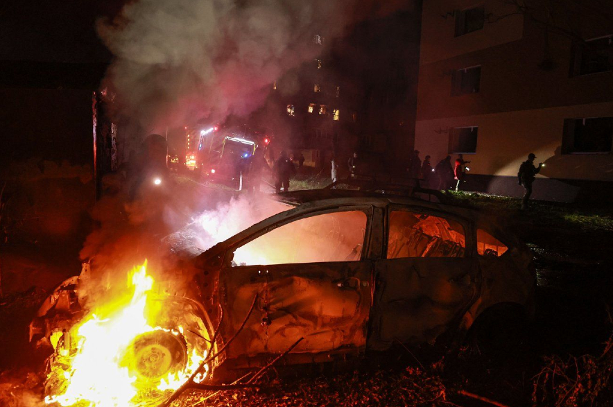 A car burns in a residential neighborhood in Zaporizhzhia, Ukraine.