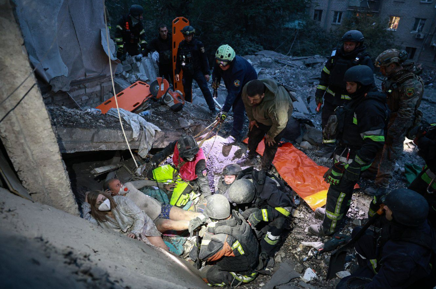 Rescue workers pull a family from the rubble of a residential building destroyed by a Russian airstrike in Zaporizhzhia.
