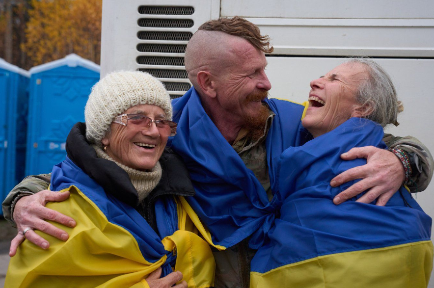 A Ukrainian serviceman Dmytro, centre, hugs his family.