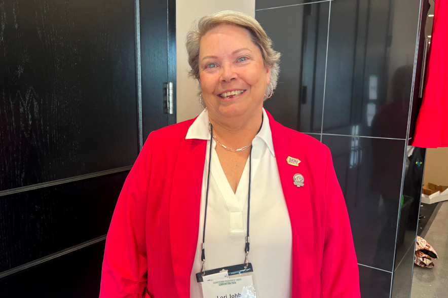 Labour leader Lori Johb smiles in a portrait photo.