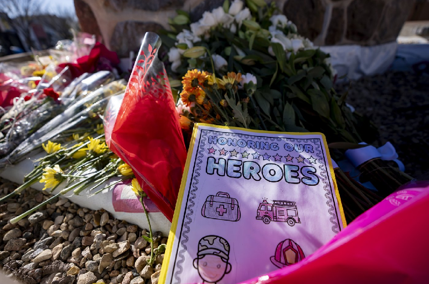 Flowers and messages are laid for the victims of a fire that killed four soldiers at CFB Wainwright, at the Memorial Clock Tower on Main Street in Wainwright, Alta., on Tuesday, Oct. 20, 2026.