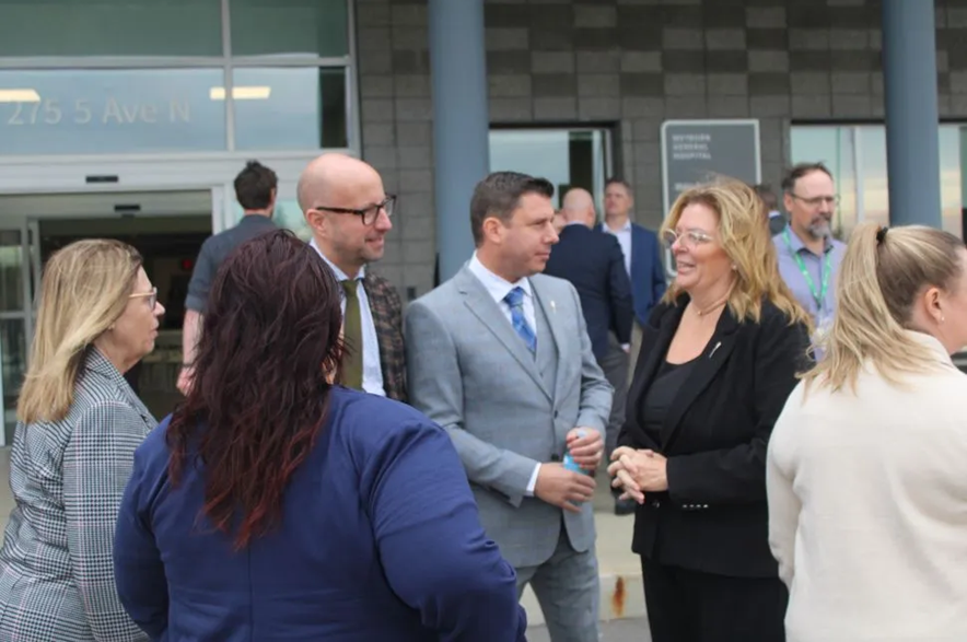 Sean Wilson, Saskatchewan's minister of SaskBuilds and Procurement, Mike Weger, Weyburn-Bengough MLA and minister of community safety, and Lori Carr, minister of mental health and addiction, seniors and rural and remote health, speak together following the announcement at the grand opening of the new Weyburn General Hospital.