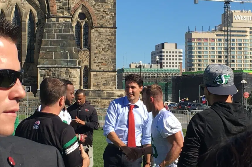Roughriders practice on Parliament Hill with the Prime Minister
