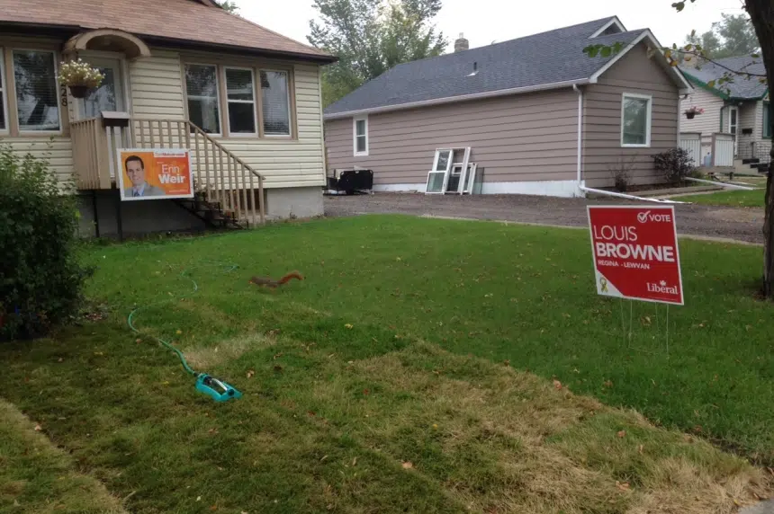 Regina households divided: election candidates signs battle for lawn dominance
