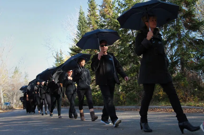Black-clad marchers bring attention to human trafficking